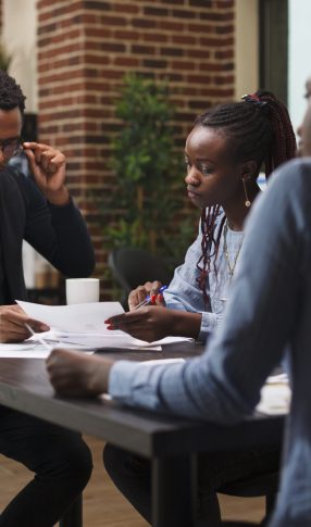 african american research agency coworkers in meeting about startup project financial status. african american research agency coworkers in meeting about startup project financial status.